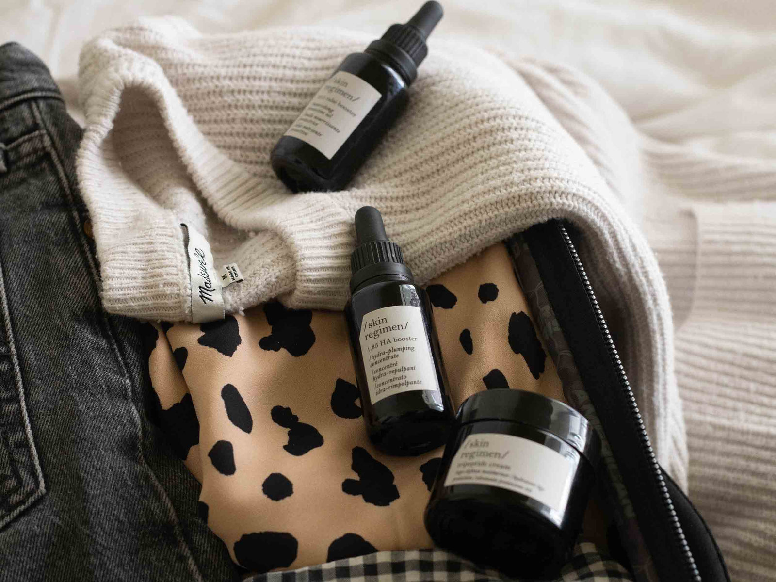 essential skincare products in a travel bag