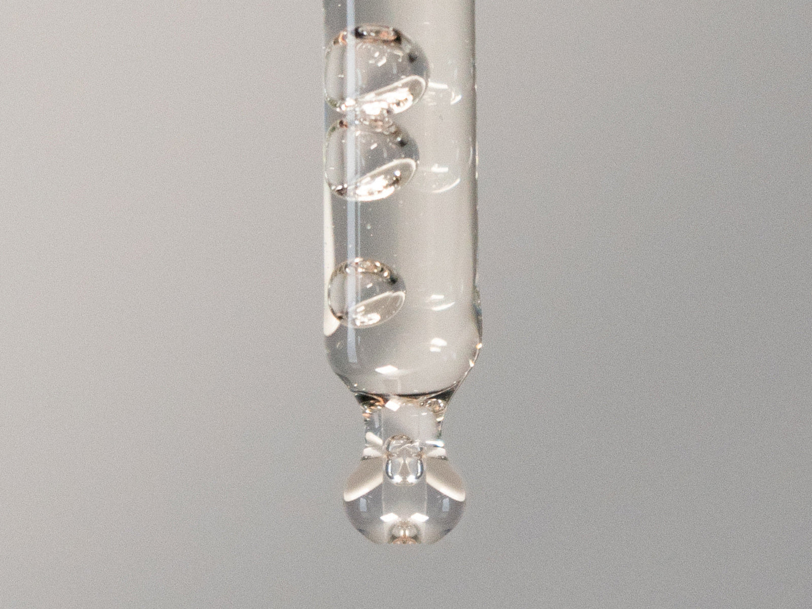 vitamin c serum and salicylic acid texture shot on a grey background