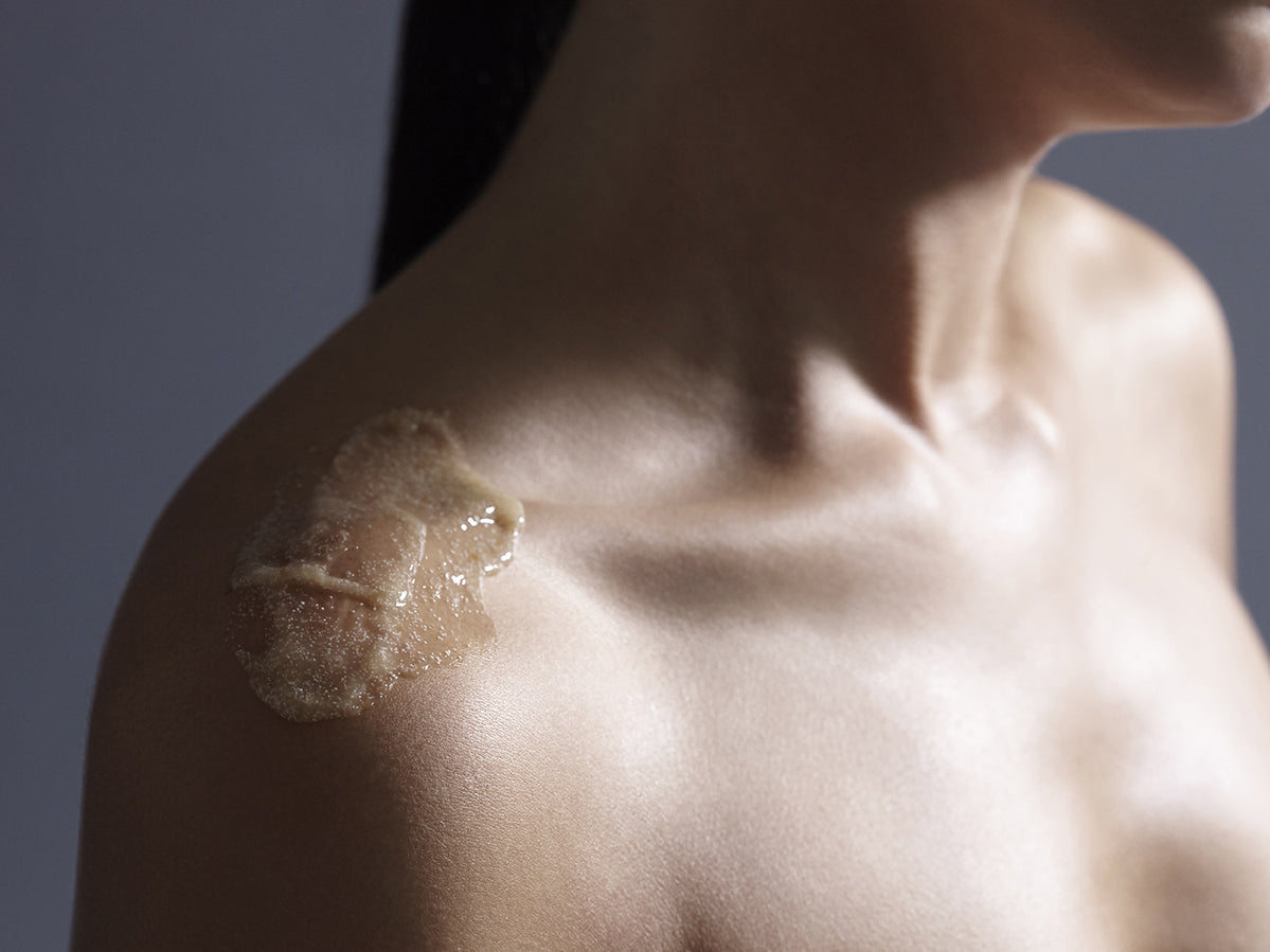 woman applying body scrub 