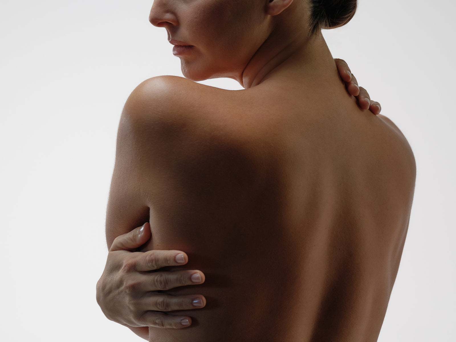 woman holding her skin