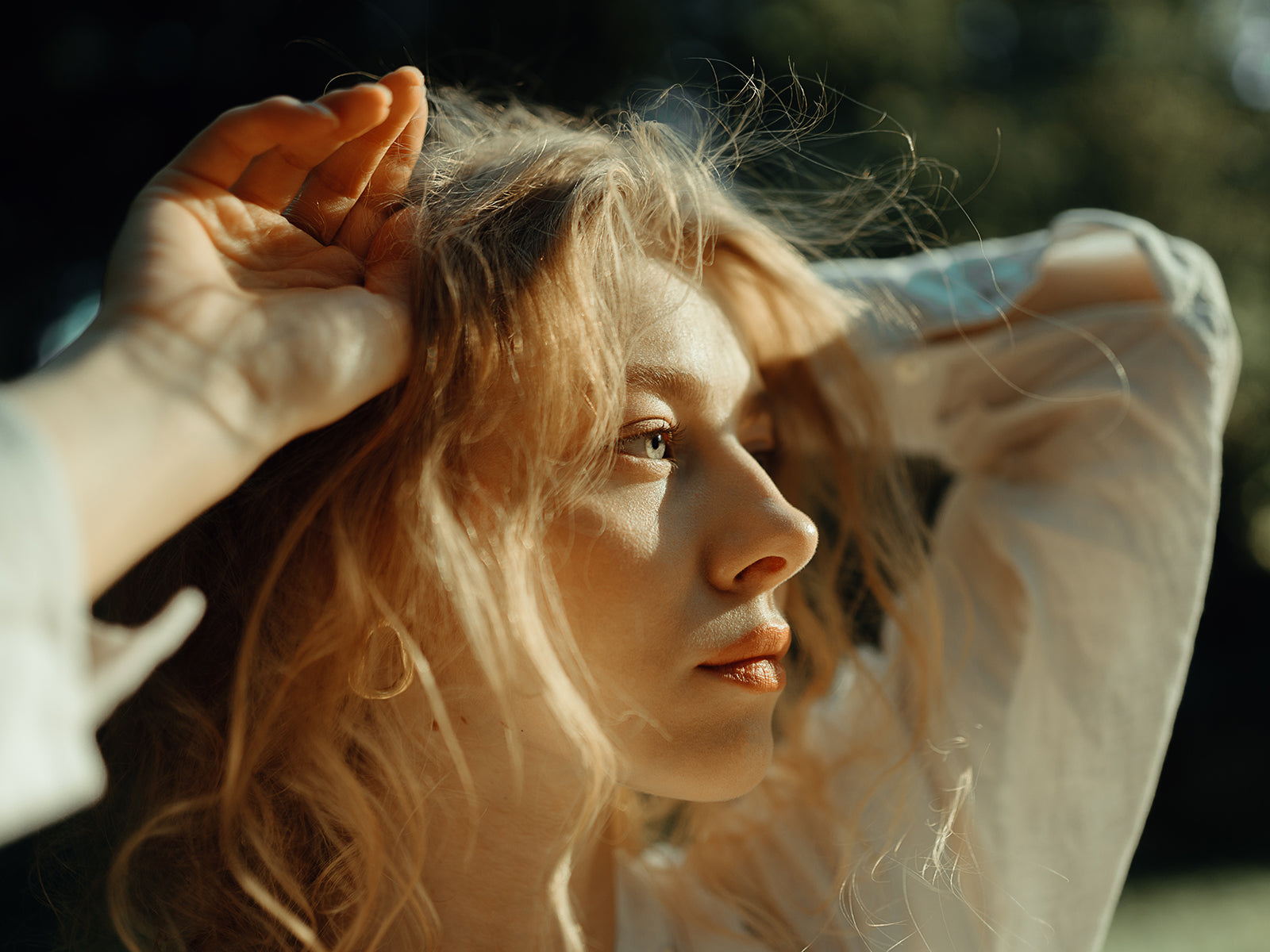 woman with healthy skin looking at the sun
